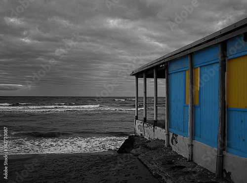 A beach with a pier in the background photo