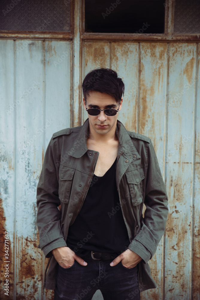 Young man wearing jacket and sunglasses oudoors Young man wearing jacket and sunglasses oudoors