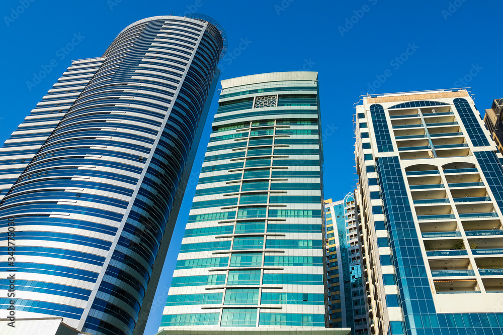 Panorama of the center of the Emirate of Sharjah, United Arab Emirates . Real estate in United Arab Emirates . Construction of skyscrapers in the modern city center Panorama of the center of the Emirate of Sharjah, United Arab Emirates . Real estate in United Arab Emirates . Construction of skyscrapers in the modern city center