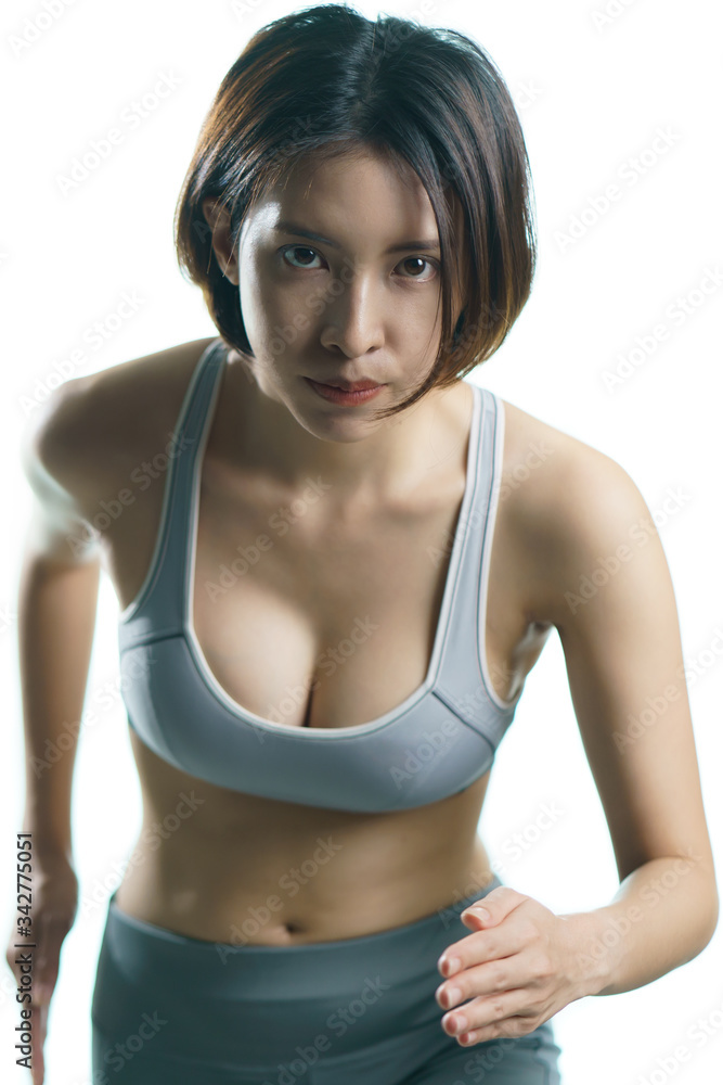 Young woman in gray sportswear exercise at home, doing jogging in place, in quarantine during Coronavirus pandemic. Young woman in gray sportswear exercise at home, doing jogging in place, in quarantine during Coronavirus pandemic.