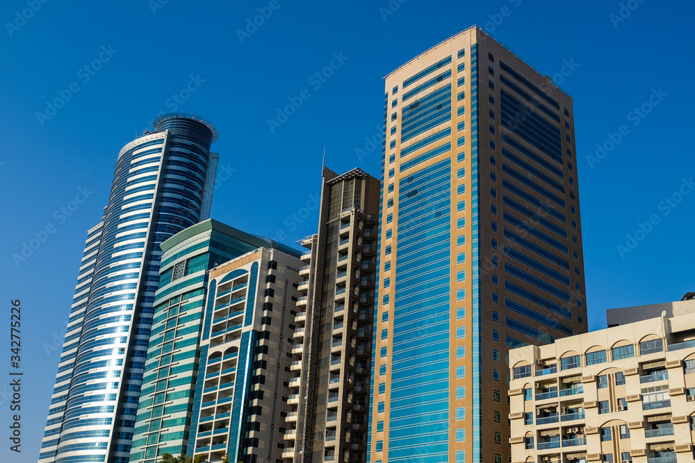 Panorama of the center of the Emirate of Sharjah, United Arab Emirates . Real estate in United Arab Emirates . Construction of skyscrapers in the modern city center Panorama of the center of the Emirate of Sharjah, United Arab Emirates . Real estate in United Arab Emirates . Construction of skyscrapers in the modern city center