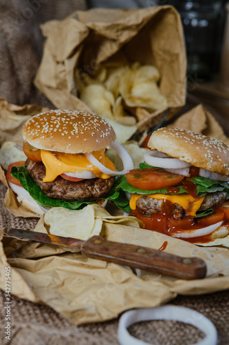 Street food, fast food. Homemade juicy burgers with beef, cheese and caramelized onions