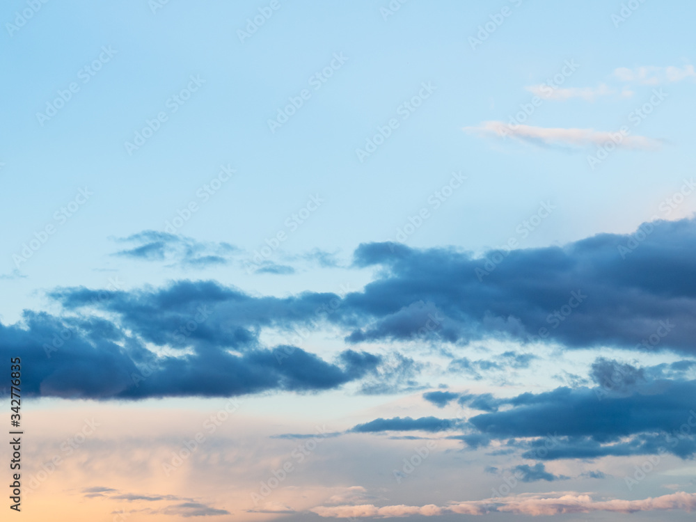 Obraz premium dark clouds in blue sky at spring sunset