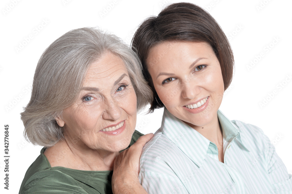 Portrait of mother and her adult daughter hugging isolated on white Portrait of mother and her adult daughter hugging isolated on white
