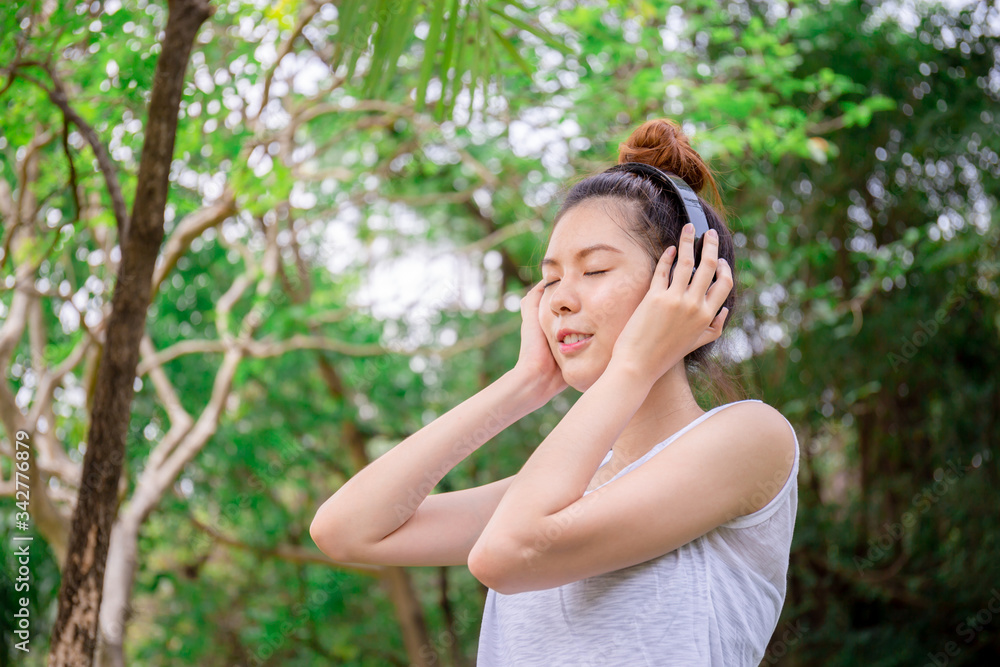 Beautiful young woman with headphones enjoying and relaxed in music in the park Beautiful young woman with headphones enjoying and relaxed in music in the park