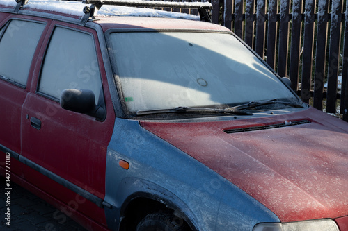 Automobile  vehicle and car in the winter and wintertime. Rime  glaze ice and glazed frost on the bodywork and windshield. 