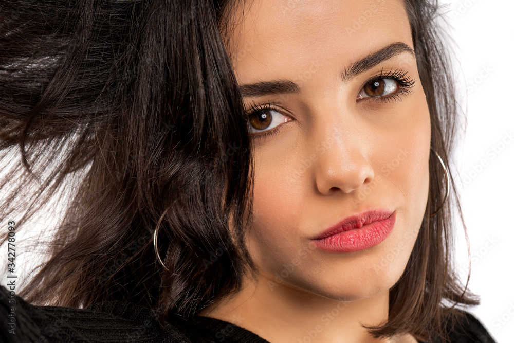 Brunette girl holding her black hair isolated on white background. Portrait of beauty girl. Brunette girl holding her black hair isolated on white background. Portrait of beauty girl.