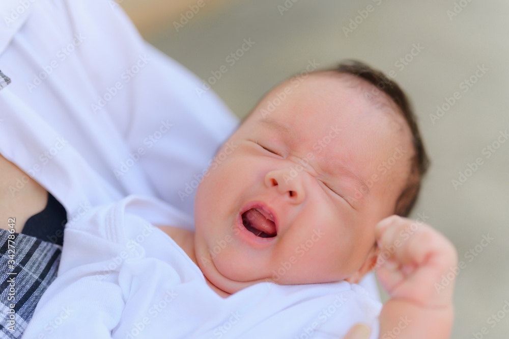 Asian woman holding a newborn baby in her arms at home.Mother day and newborn baby infant health care concept. Asian woman holding a newborn baby in her arms at home.Mother day and newborn baby infant health care concept.