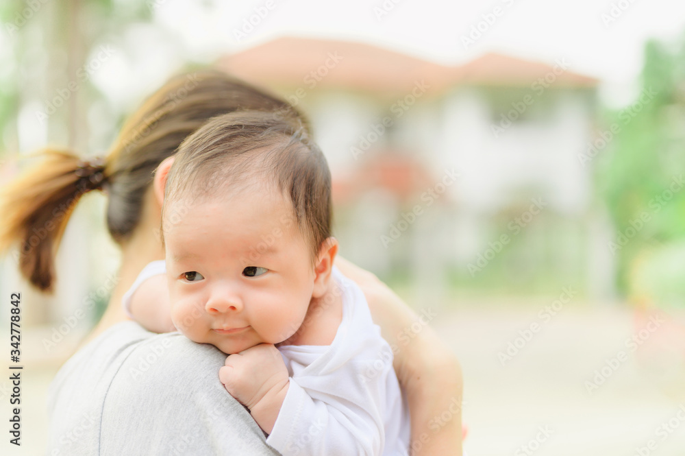 Asian woman holding a newborn baby in her arms at home.Mother day and newborn baby infant health care concept. Asian woman holding a newborn baby in her arms at home.Mother day and newborn baby infant health care concept.