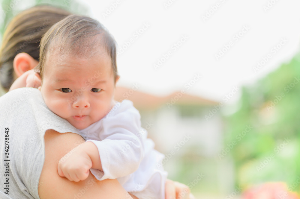 Asian woman holding a newborn baby in her arms at home.Mother day and newborn baby infant health care concept. Asian woman holding a newborn baby in her arms at home.Mother day and newborn baby infant health care concept.