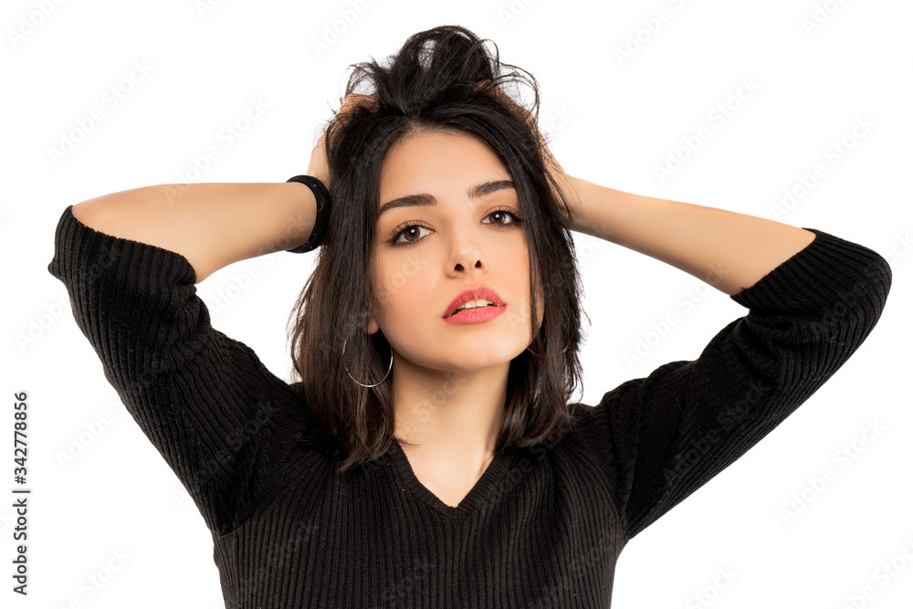 Brunette girl holding her black hair isolated on white background. Portrait of beauty girl.
