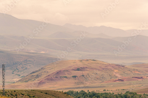 gentle red hills, journey through mountain valley, pastures for animals, soil erosion in arid steppe