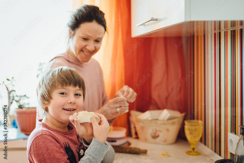 Mother and son making dumplings. Cooking home Mother and son making dumplings. Cooking home