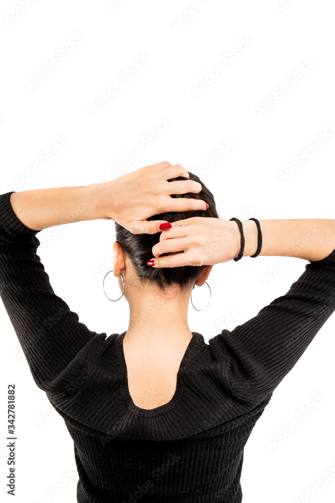 Brunette girl holding her black hair isolated on white background. Portrait of beauty girl. Brunette girl holding her black hair isolated on white background. Portrait of beauty girl.