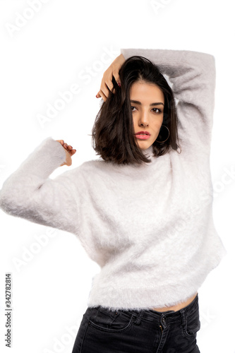 Brunette girl holding her black hair isolated on white background. Portrait of beauty girl.