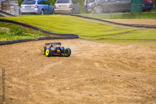 1/8 RC electric buggy drifting through a corner on an offroad track