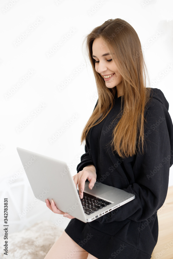 Young beautiful female freelancer is working on a laptop computer from home with a laptop, workflow concept, Young beautiful female freelancer is working on a laptop computer from home with a laptop, workflow concept,