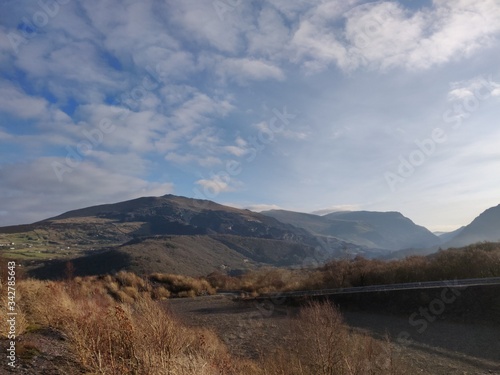 Fototapeta Naklejka Na Ścianę i Meble -  Snowdonia mountain view with beautiful blue sky, and greenery.