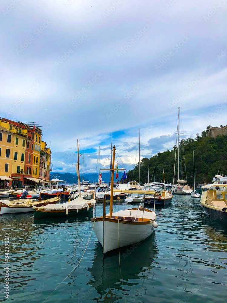 Scenic view of yachts and boats moored in the harbor of Portofino on the Italian Riviera. Mediterranean landscape.