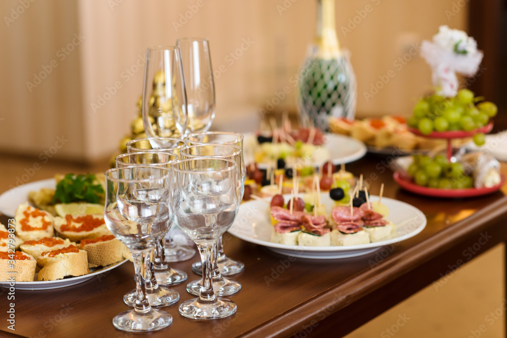 Served banquet decorated table. Wedding decorations in banquet hall. Delicious meal