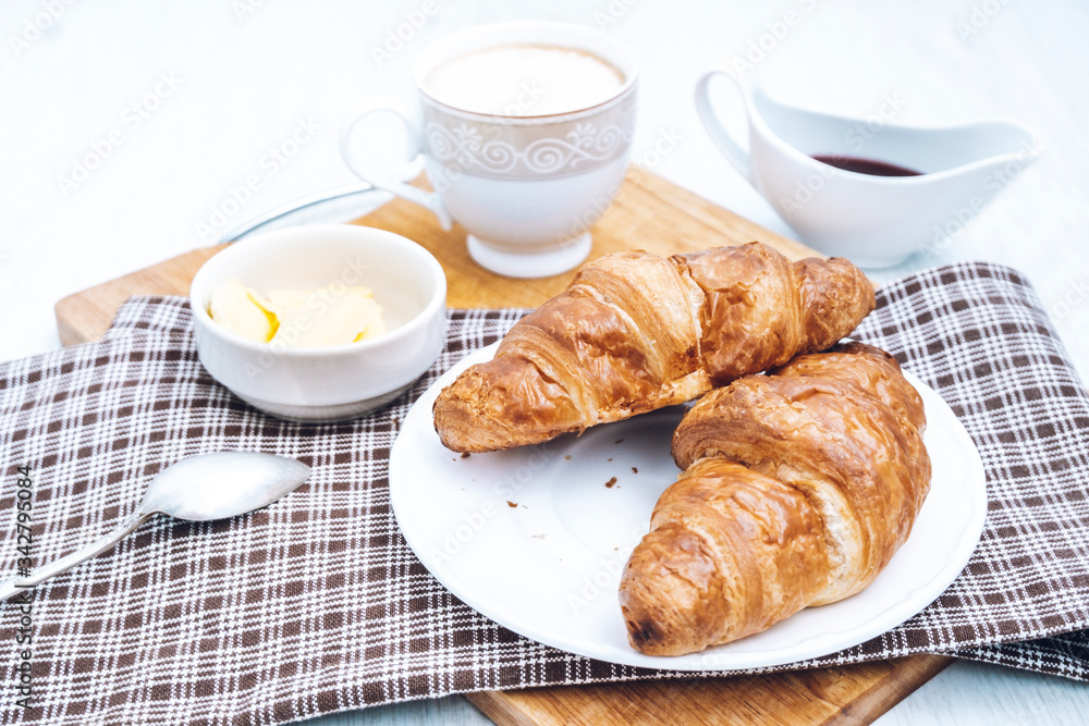 Coffee with croissants for breakfast. Two classic croissants. Tasty french breakfast. Coffee with croissants for breakfast. Two classic croissants. Tasty french breakfast.