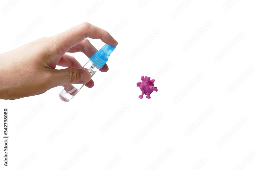 hand spraying alcohol or gel sanitized to purple coronavirus or COVID-19 sculpture by clay on white background hand spraying alcohol or gel sanitized to purple coronavirus or COVID-19 sculpture by clay on white background