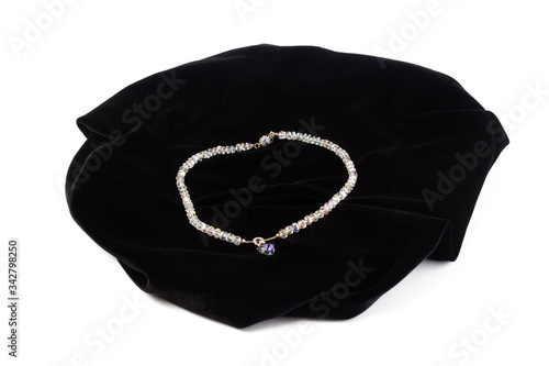 Natural Crystal Beads on Black Velvet. On a white background isolate
