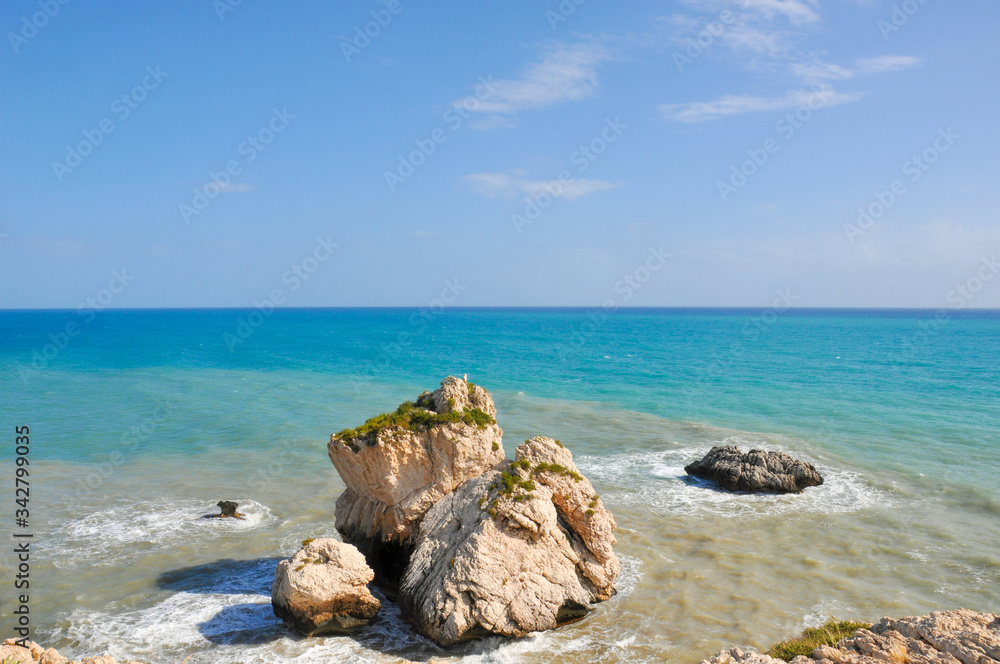Sunlit rocks in the azure sea water. The famous birthplace of beautiful Aphrodite.