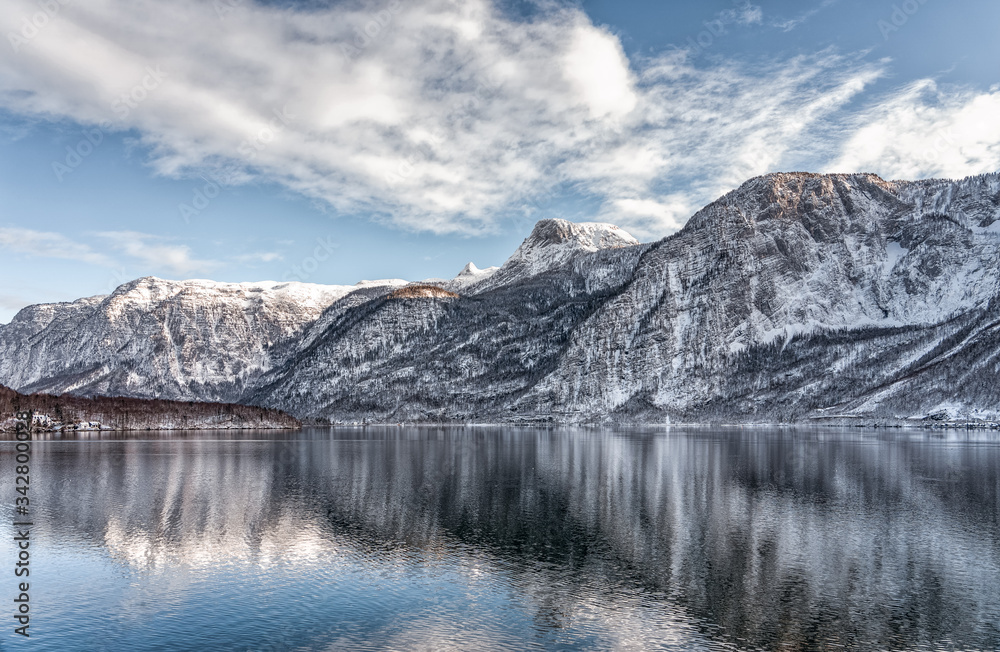 Snowy mountain by lake Hallstatt in upper Austria with clear sky in winter