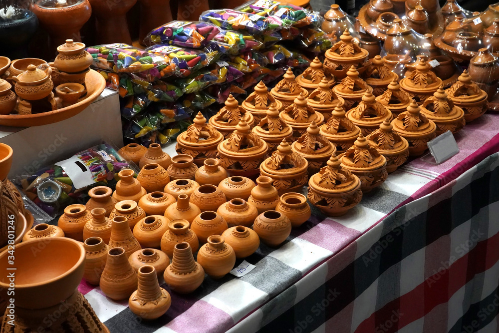 A lot of small handcraft pottery on a table.