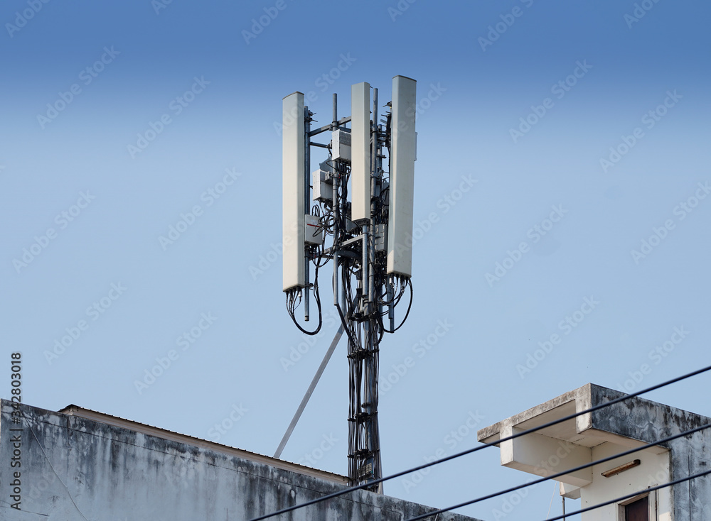 Telecommunication tower of 4G and 5G cellular. Macro Base Station. Wireless Communication Antenna Transmitter. Telecommunication tower with antennas against blue sky background. Telecommunication tower of 4G and 5G cellular. Macro Base Station. Wireless Communication Antenna Transmitter. Telecommunication tower with antennas against blue sky background.