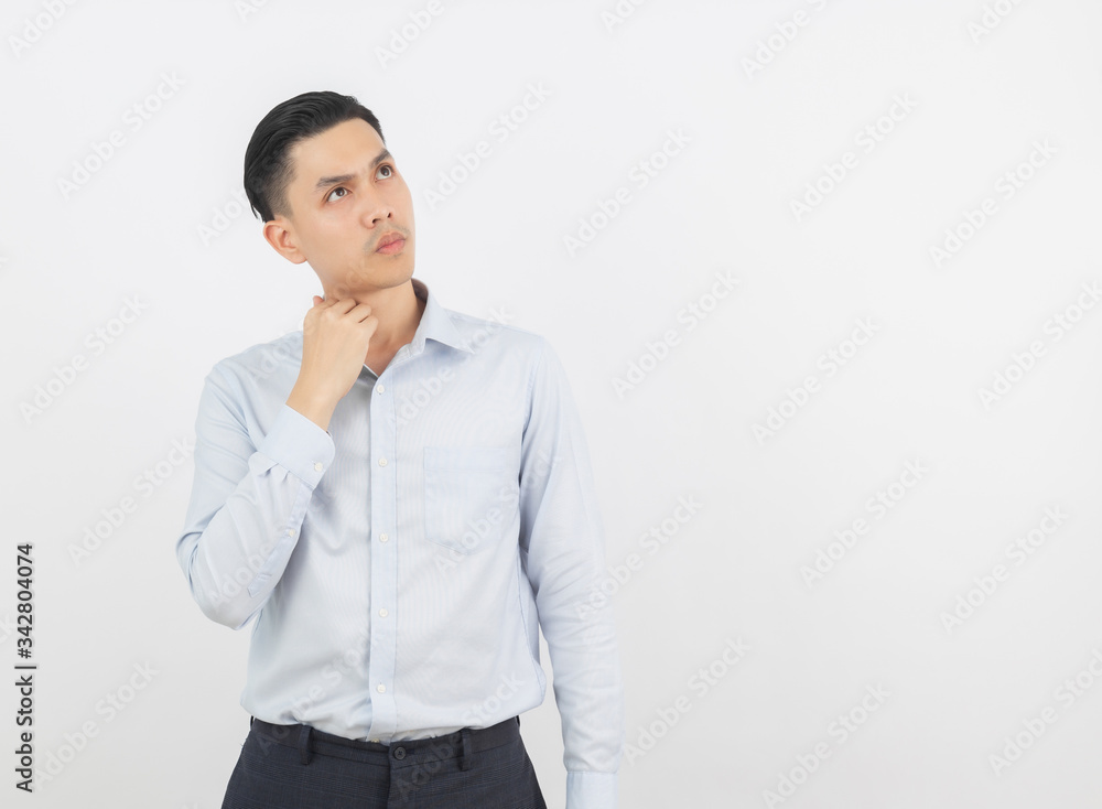 Young handsome asian business man thinking an idea while looking up isolated on white background. Young handsome asian business man thinking an idea while looking up isolated on white background.