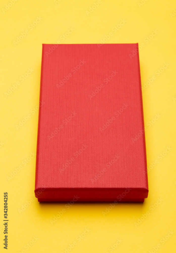 Fototapeta premium Red box product packaging isolated on yellow background.