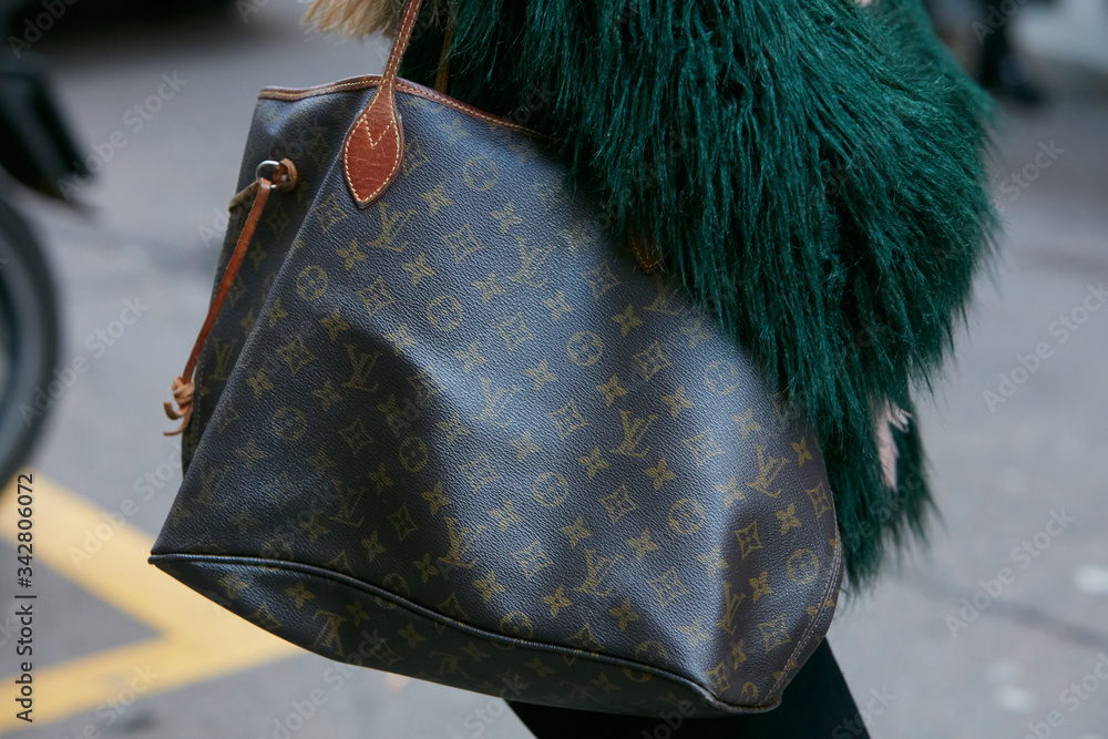 Woman with Louis Vuitton bag and green fur coat on February 25, 2017 in  Milan, Italy Stock Photo | Adobe Stock