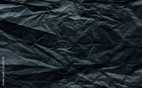 crumpled dark gray wrapping paper slightly blurred