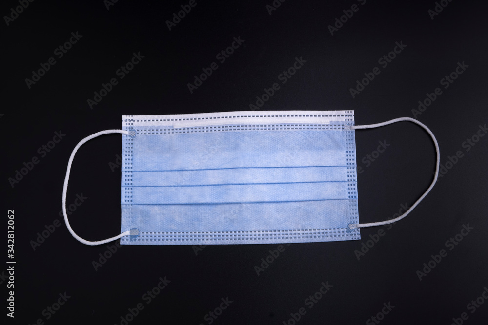 Medical mask for protect COVID-19 on blac k background Medical mask for protect COVID-19 on blac k background