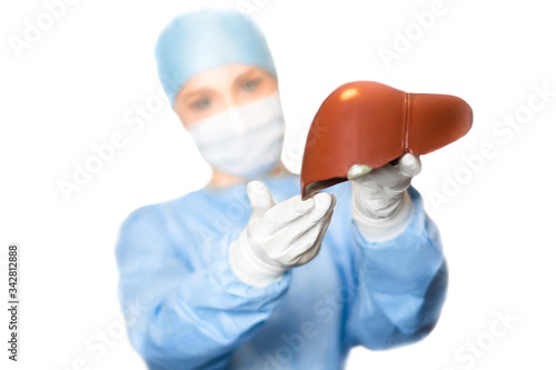 Liver and surgeon doctor, focus on the liver, horizontal