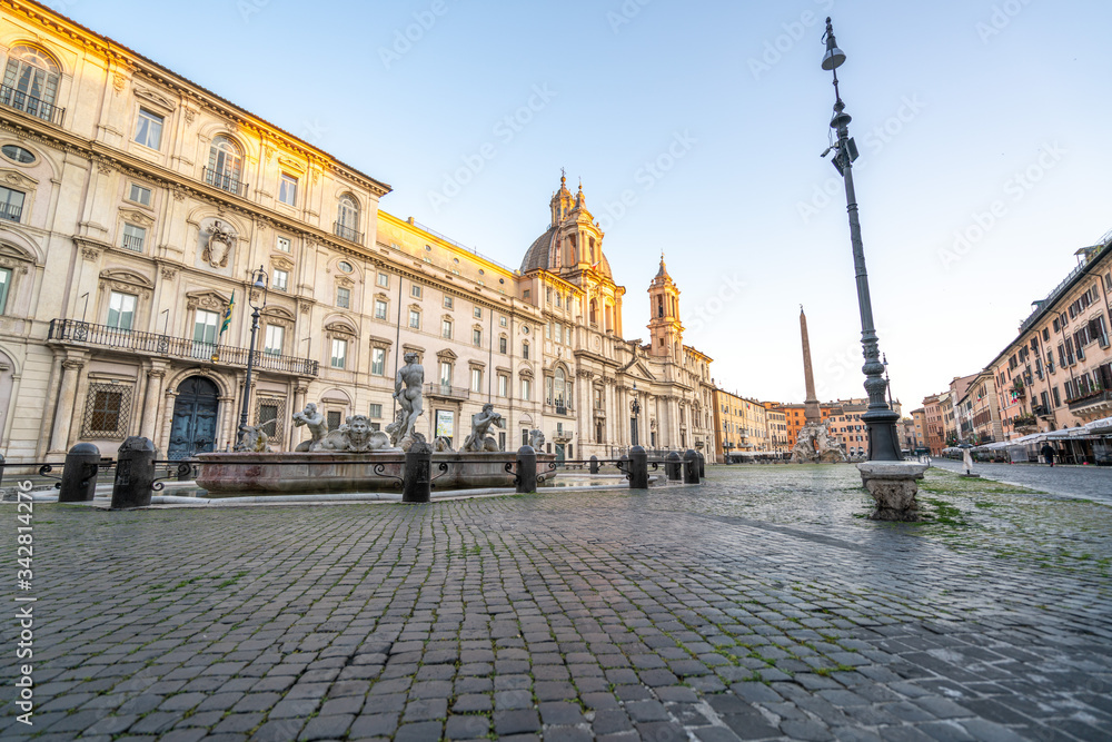 Piazza Navona in Rome appears like a ghost city during the covid emergency  lock down, grass on the floor