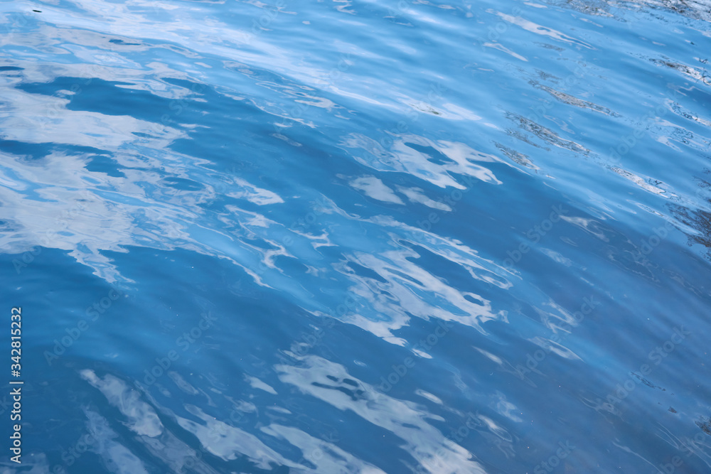 Background from the blue surface of the water of the sea, ocean. Smooth the water. Background from the blue surface of the water of the sea, ocean. Smooth the water.
