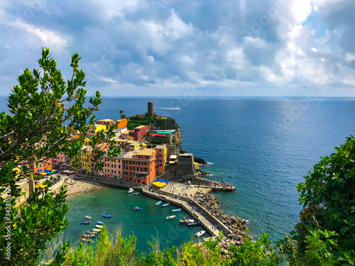 Gorgeous aerial view of the bay in Vernazza. Landscape of Santa Margherita di Antiochia Church, the medieval Doria Castle and marina on a beautiful sunny day. Cinque Terre, Ligurian coast, Italy.