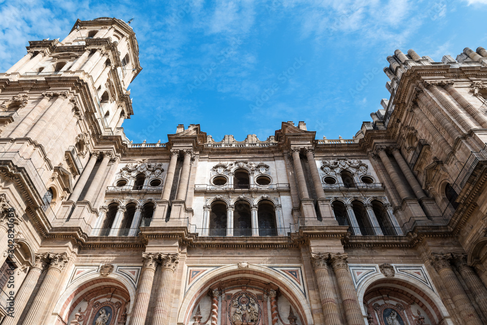 Low-angle view of the main facade of the Roman Catholic Cathedral of Málaga in southern Spain.