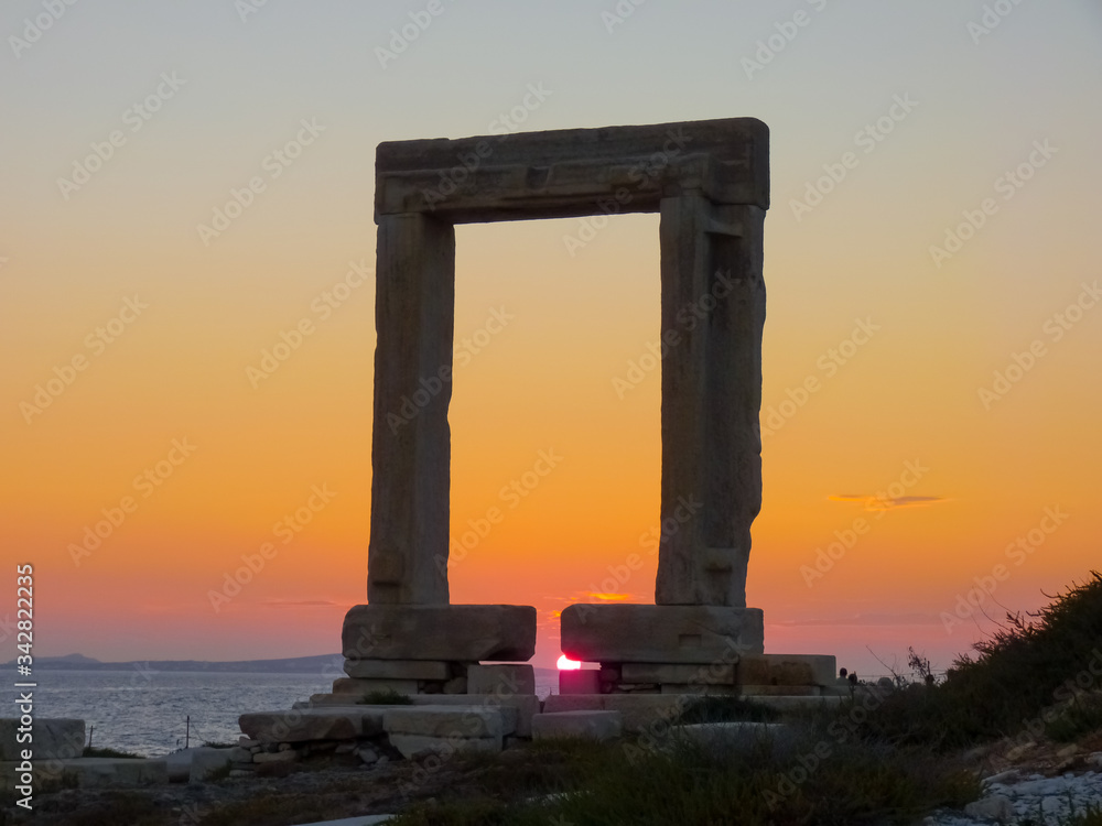 Sunset on Portara - ruins of ancient temple of Delian Apollo on Naxos island, Cyclades, Greece