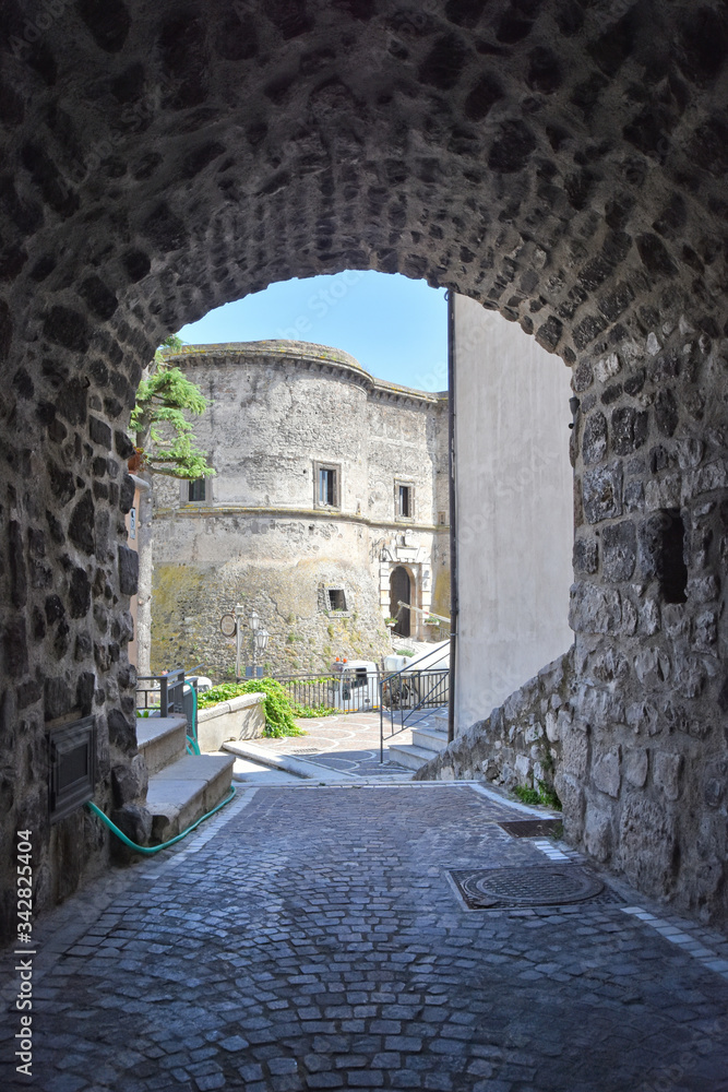 A narrow street between the old houses of the village of Faicchio in the province of Benevento, Italy