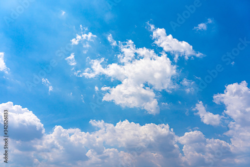 Sunlights and cumulus clouds like cotton floating on blue sky