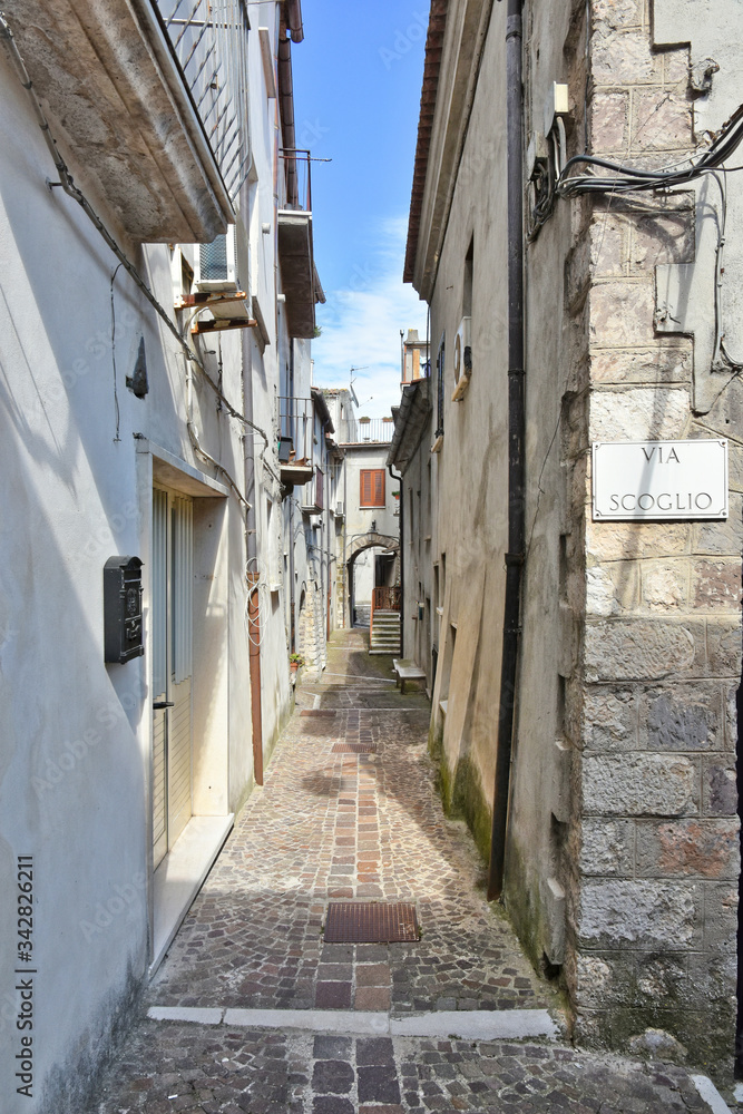 A narrow street between the old houses of the village of Faicchio in the province of Benevento, Italy