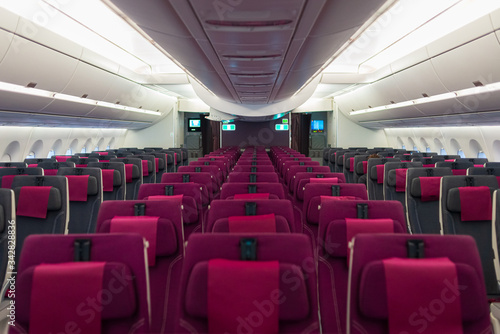 Empty aircraft cabin interior due to covid-19 medical global emergency pandemy. Transportation lockdown airline company economy default. No passenger on commercial plane.