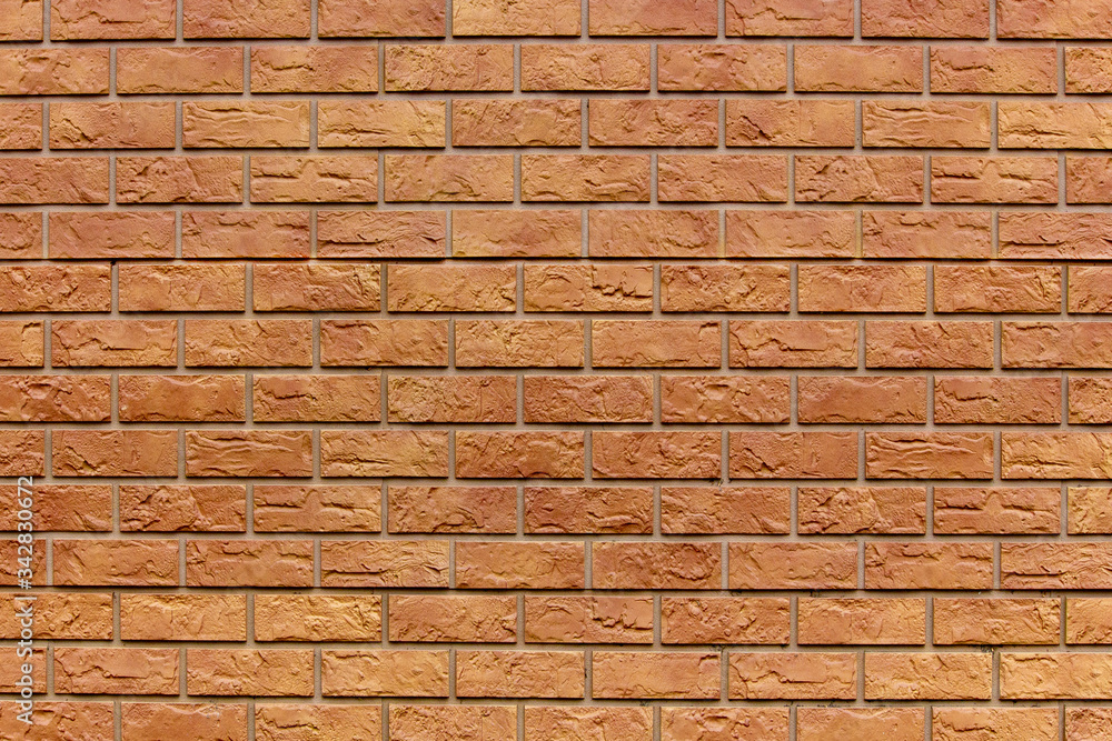 Fototapeta premium Brick texture. Orange background. Brown wallpaper for designer. Rectangular photo, image.