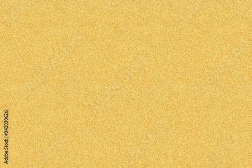 Seamless texture of light yellow sand on the sea coast. Rectangular photo. Background for designer.
