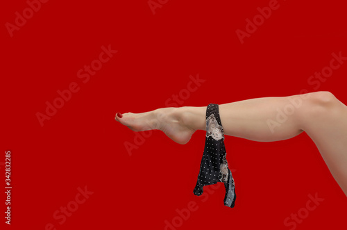 Bild auf Leinwand Black panties on slender female leg