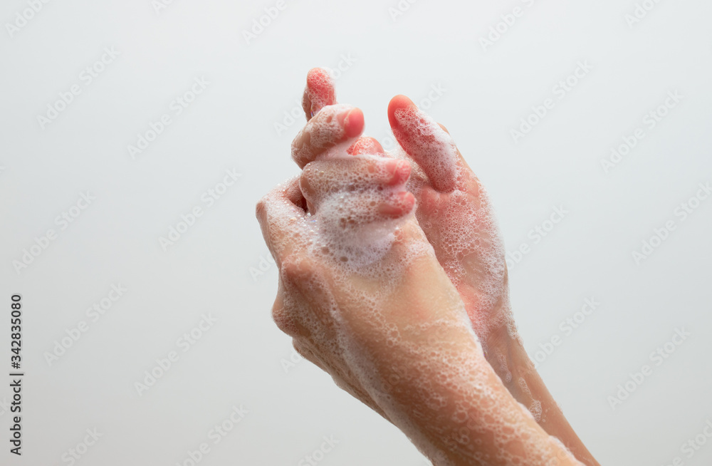Fototapeta premium Washing hands with soap. Corona virus pandemic prevention wash hands with soap warm water and , rubbing nails and fingers washing frequently or using hand sanitizer gel